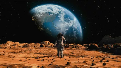 Following Shot of Brave Astronaut in Space Suit Confidently Walking on Mars Towards Earth Planet. Earth Planet as viewed from Mars surface. The surface of Mars, strewn with small rocks and red sand. Martian landscape in rusty orange shades, Mars Planet surface, Desert, Cliffs, sand. Red planet mars. Alien Red Planet Covered in Rocks. First Astronaut On the Mars. Big Moment for the Human Race. Advanced Technologies, Space Exploration/ Travel, Colonization Concept. / Foto: Nzoka John