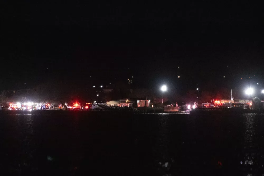 Emergency response can be seen set up at Joint Base Anacostia Bolling, Wednesday night, Jan. 29, 2025 in Washington, across the Potomac River from Ronald Reagan Washington National Airport, Arlington, Va. (AP Photo/Kevin Wolf)