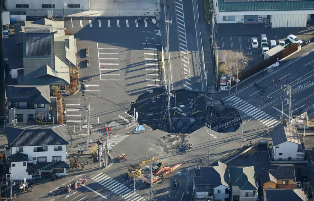 An aerial view shows a large sinkhole that formed when a sinkhole that swallowed a truck and a man believed to be its driver at an intersection in Yashio, formed on January 28, 2025, and another that formed during rescue operations, merged, near Tokyo, Japan January 30, 2025, in this photo taken by Kyodo. Kyodo/via REUTERS ATTENTION EDITORS - THIS IMAGE HAS BEEN SUPPLIED BY A THIRD PARTY. MANDATORY CREDIT. JAPAN OUT. NO COMMERCIAL OR EDITORIAL SALES IN JAPAN.