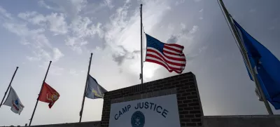 FILE In this photo reviewed by U.S. military officials, flags fly at half-staff at Camp Justice, Aug. 29, 2021, in Guantanamo Bay Naval Base, Cuba. The Defense Department says Sufiyan Barhoumi, an Algerian man imprisoned at the Guantanamo Bay detention center for nearly 20 years, has been released and sent back to his homeland. (AP Photo/Alex Brandon, File)