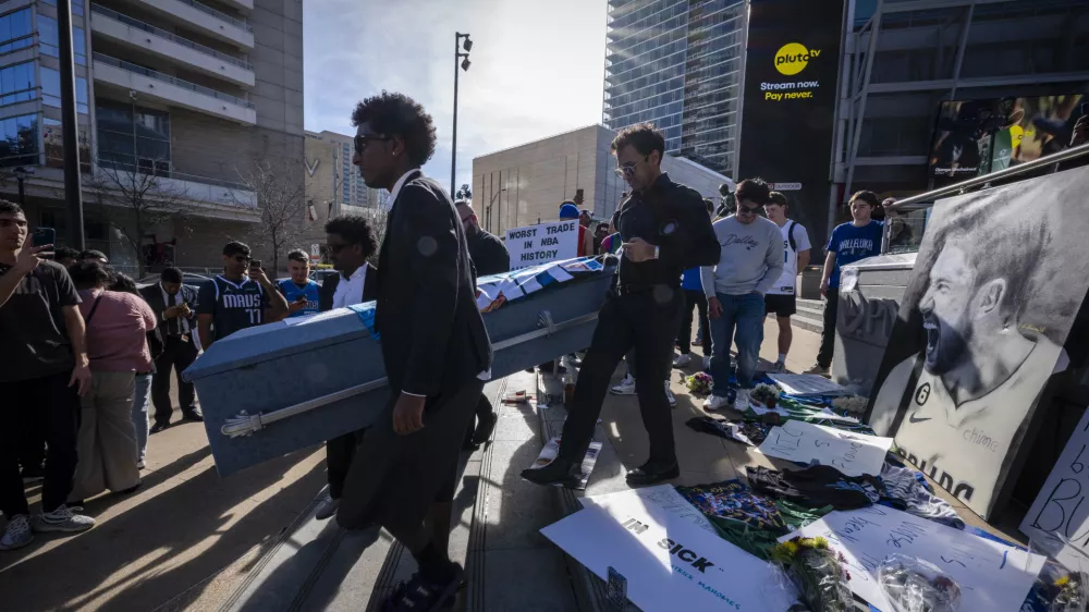 Feb 2, 2025; Dallas, Texas, USA; Dallas Mavericks fans walk to the arena with a coffin during a mock funeral before the game between the Dallas Stars and the Columbus Blue Jackets at American Airlines Center to protest the trade of Mavericks point guard Luka Doncic to the Los Angeles Lakers. Mandatory Credit: Jerome Miron-Imagn Images