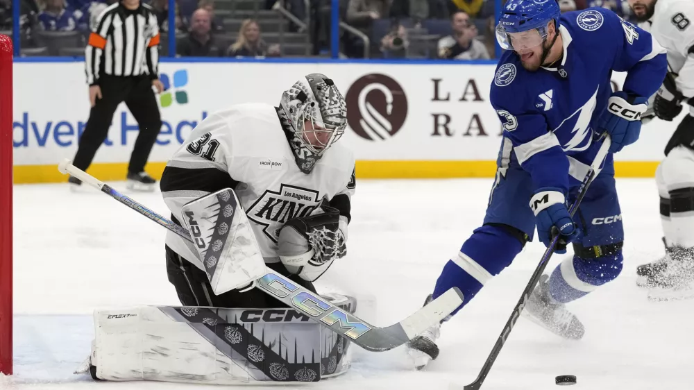 Los Angeles Kings goaltender David Rittich (31) makes a sve on a shot by Tampa Bay Lightning defenseman Darren Raddysh (43) during the second period of an NHL hockey game Thursday, Jan. 30, 2025, in Tampa, Fla. (AP Photo/Chris O'Meara)