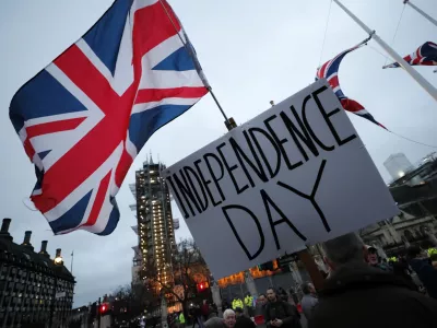 FILE - Brexit supporters gather during a rally in London, Friday, Jan. 31, 2020. Britain officially leaves the European Union on Friday after a debilitating political period that has bitterly divided the nation since the 2016 Brexit referendum. (AP Photo/Frank Augstein, File)