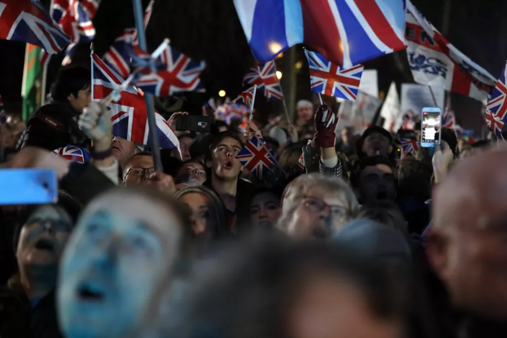 FILE - Brexit supporters celebrate during a rally in London, Friday, Jan. 31, 2020. Britain leaves the European Union after 47 years, leaping into an unknown future in historic blow to the bloc. (AP Photo/Frank Augstein, File)