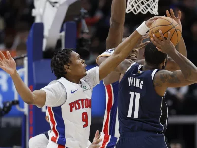 Detroit Pistons forward Ausar Thompson (9) blocks a shot-attempt by Dallas Mavericks guard Kyrie Irving (11) during the second half of an NBA basketball game Friday, Jan. 31, 2025, in Detroit. (AP Photo/Duane Burleson)