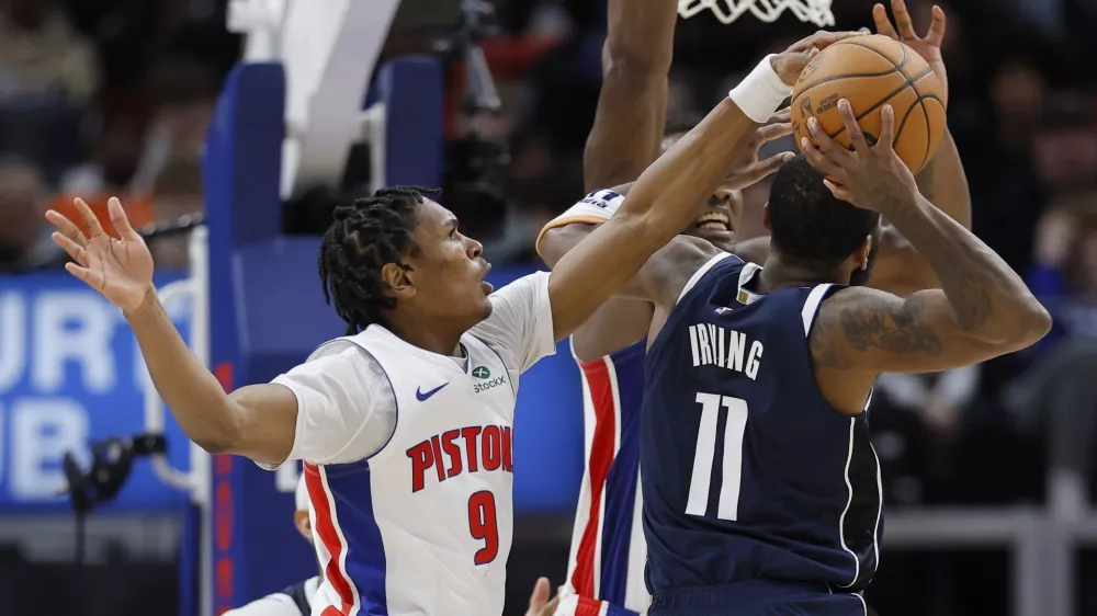 Detroit Pistons forward Ausar Thompson (9) blocks a shot-attempt by Dallas Mavericks guard Kyrie Irving (11) during the second half of an NBA basketball game Friday, Jan. 31, 2025, in Detroit. (AP Photo/Duane Burleson)