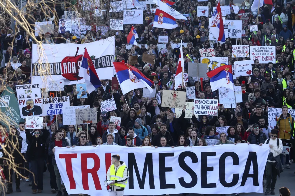 People march during a protest over the collapse of a concrete canopy that killed 15 people more than two months ago, in Novi Sad, Serbia, Saturday, Feb. 1, 2025. The front banner reads: "Three months". (AP Photo/Armin Durgut)