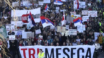 People march during a protest over the collapse of a concrete canopy that killed 15 people more than two months ago, in Novi Sad, Serbia, Saturday, Feb. 1, 2025. The front banner reads: "Three months". (AP Photo/Armin Durgut)