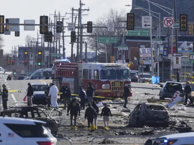 Investigators work the scene where a small plane crashed in Philadelphia, Saturday, Feb. 1, 2025. (AP Photo/Matt Rourke)