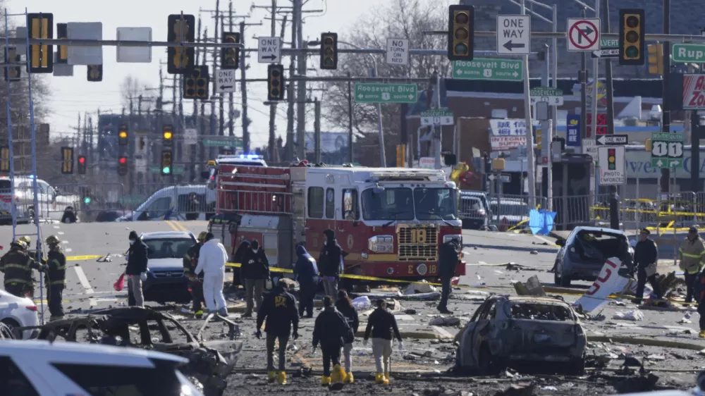 Investigators work the scene where a small plane crashed in Philadelphia, Saturday, Feb. 1, 2025. (AP Photo/Matt Rourke)