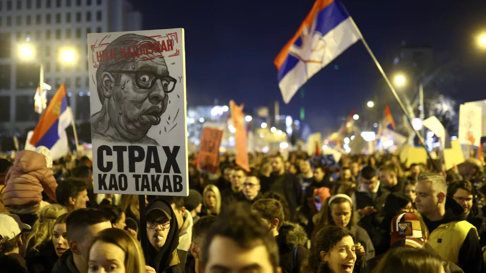 People gather during a protest over the collapse of a concrete canopy that killed 15 people more than two months ago, in Novi Sad, Serbia, Saturday, Feb. 1, 2025. The poster reads: "Not competent, fear as such".(AP Photo/Armin Durgut)