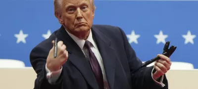 FILE - President Donald Trump throws pens used to sign executive orders to the crowd during an indoor Presidential Inauguration parade event in Washington, Monday, Jan. 20, 2025. (AP Photo/Matt Rourke, File)