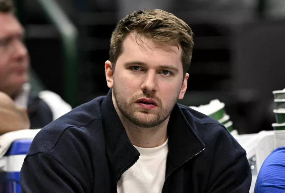 Jan 12, 2025; Dallas, Texas, USA; Dallas Mavericks guard Luka Doncic (77) reacts from the team bench during the second half of the game against the Denver Nuggets at the American Airlines Center. Mandatory Credit: Jerome Miron-Imagn Images