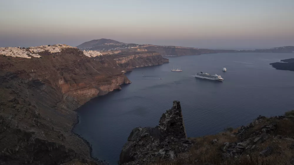 FILE - Ruins of a settlement, including a former Catholic monastery, lie on the rocky promontory of Skaros on the Greek island of Santorini, on June 15, 2022. (AP Photo/Petros Giannakouris, File)