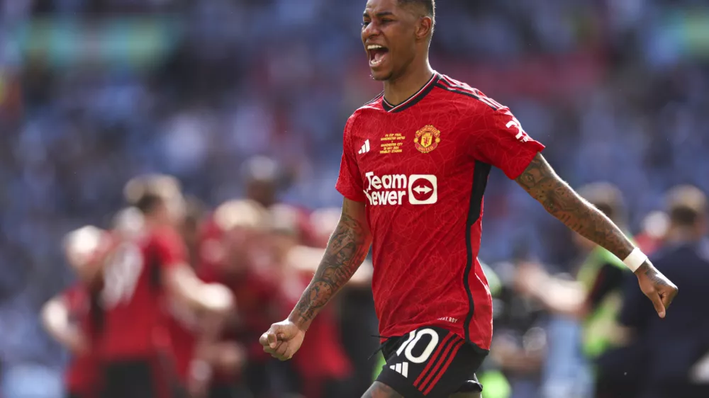 FILE - Manchester United's Marcus Rashford celebrates after his team won the English FA Cup final soccer match between Manchester City and Manchester United at Wembley Stadium in London, on May 25, 2024. (AP Photo/Ian Walton, File)