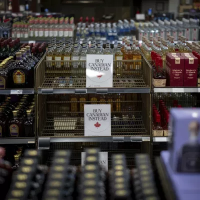 A sign is placed in front of the American whiskey section at a B.C. Liquor Store after top selling American made products have been removed from shelves in Vancouver, B.C., Sunday, Feb. 2, 2025. (Ethan Cairns/The Canadian Press via AP)