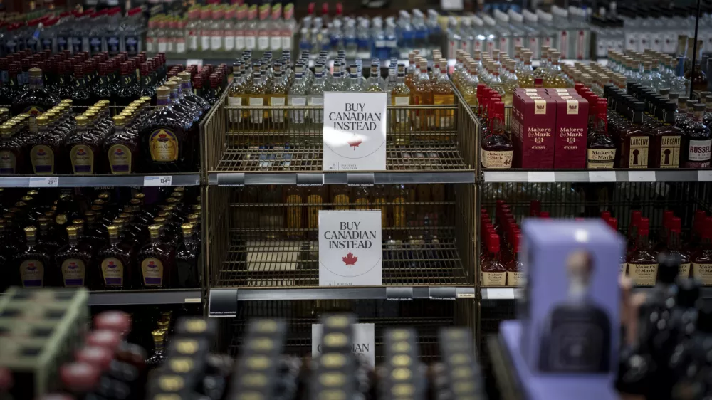 A sign is placed in front of the American whiskey section at a B.C. Liquor Store after top selling American made products have been removed from shelves in Vancouver, B.C., Sunday, Feb. 2, 2025. (Ethan Cairns/The Canadian Press via AP)