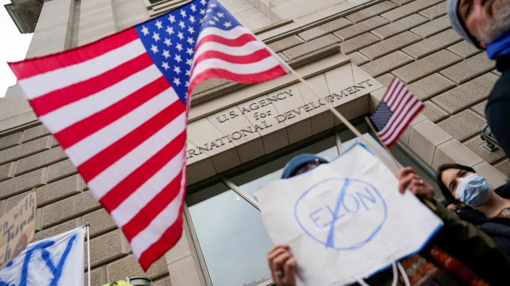 People hold placards outside the USAID building, after billionaire Elon Musk, who is heading U.S. President Donald Trump's drive to shrink the federal government, said work is underway to shut down the U.S. foreign aid agency USAID, in Washington, U.S., February 3, 2025. REUTERS/Kent Nishimura