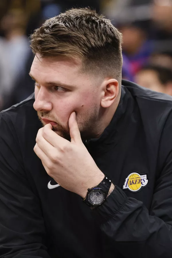 Los Angeles Lakers guard Luka Doncic sits on the bench before an NBA basketball game against the Los Angeles Clippers, Tuesday, Feb. 4, 2025, in Inglewood, Calif. (AP Photo/Kevork Djansezian)