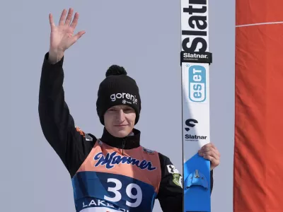 Lovro Kos of, Slovenia, celebrates his victory in the Men's Large Hill HS128 individual World Cup ski jumping competition, Saturday, Feb. 10, 2024, in Lake Placid, N.Y. (AP Photo/Robert F. Bukaty)