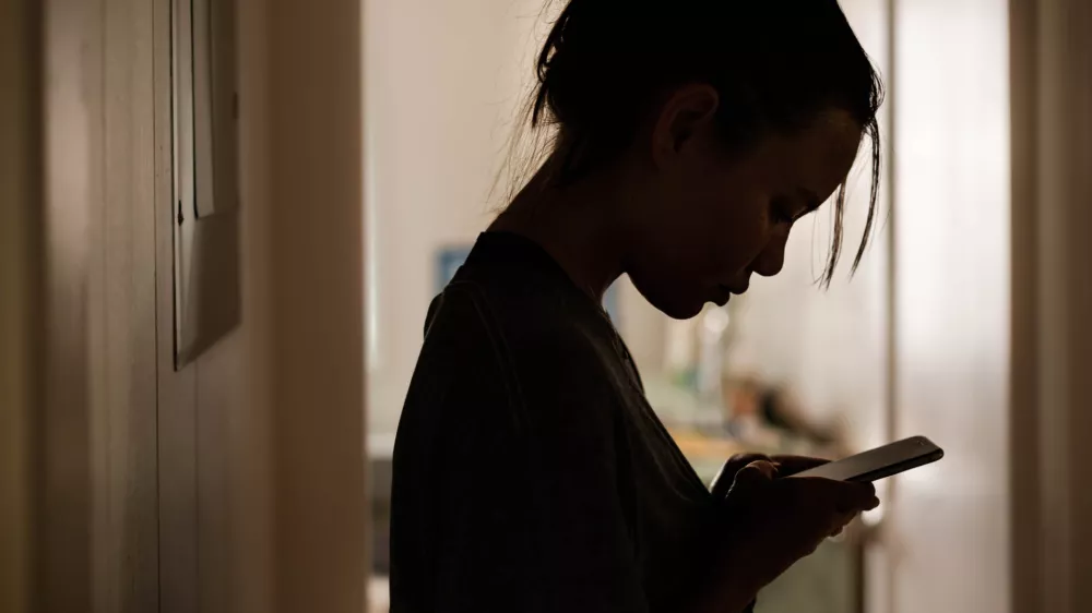 Silhouette of a gloomy girl getting a serious message