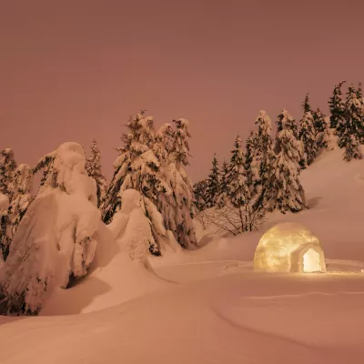 RA5PX9 Winter wonderland with igloo snow. Night scene with snow firs and snowdrift. Landscape in red