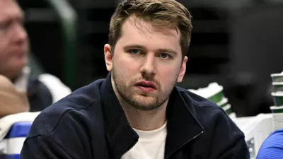 Jan 12, 2025; Dallas, Texas, USA; Dallas Mavericks guard Luka Doncic (77) reacts from the team bench during the second half of the game against the Denver Nuggets at the American Airlines Center. Mandatory Credit: Jerome Miron-Imagn Images