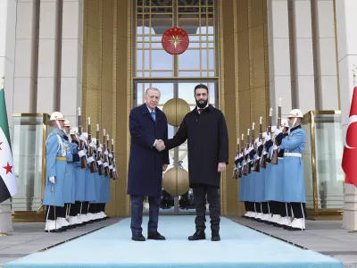 In this photo released by the Turkish Presidency, Turkish President Recep Tayyip Erdogan, center left, shakes hands with Syria's interim President Ahmad al-Sharaa during an official welcome ceremony prior to their meeting at the presidential palace in Ankara, Turkey, Tuesday, Feb. 4, 2025. (Turkish Presidency via AP)