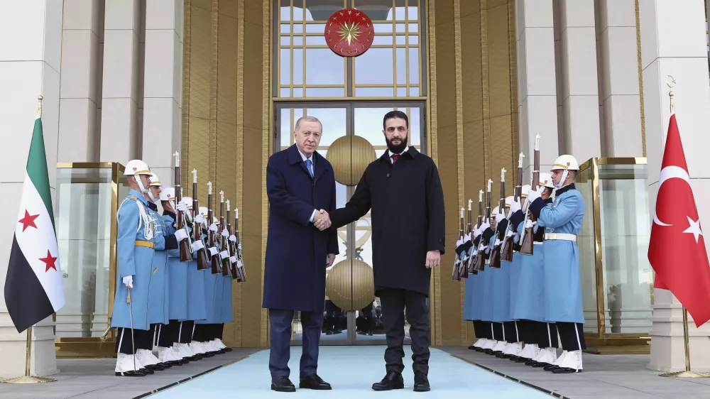 In this photo released by the Turkish Presidency, Turkish President Recep Tayyip Erdogan, center left, shakes hands with Syria's interim President Ahmad al-Sharaa during an official welcome ceremony prior to their meeting at the presidential palace in Ankara, Turkey, Tuesday, Feb. 4, 2025. (Turkish Presidency via AP)