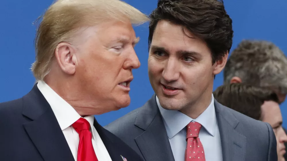 FILE - U.S. President Donald Trump, left, and Canadian Prime Minister Justin Trudeau talk prior to a NATO round table meeting at The Grove hotel and resort in Watford, Hertfordshire, England, Dec. 4, 2019. (AP Photo/Frank Augstein, File)