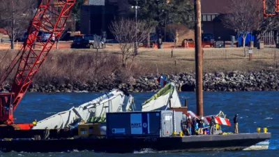 A crane retrieves part of the wreckage from the Potomac River, in the aftermath of the collision of American Eagle flight 5342 and a Black Hawk helicopter that crashed into the river, by the Ronald Reagan Washington National Airport, in Arlington, Virginia, U.S., February 4, 2025. REUTERS/Eduardo Munoz