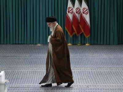 FILE - Iranian Supreme Leader Ayatollah Ali Khamenei arrives to vote for the parliamentary runoff elections, in Tehran, Iran, Friday, May 10, 2024. (AP Photo/Vahid Salemi, File)