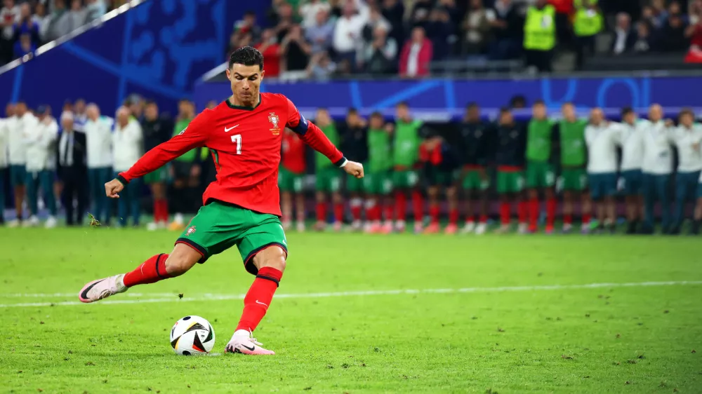 FILED - 05 July 2024, Hamburg: Portugal's Cristiano Ronaldo shoots his penalty during the UEFA EURO 2024 quarter-final soccer match between Portugal and France at the Volksparkstadion Hamburg. Photo: Jens Büttner/dpa