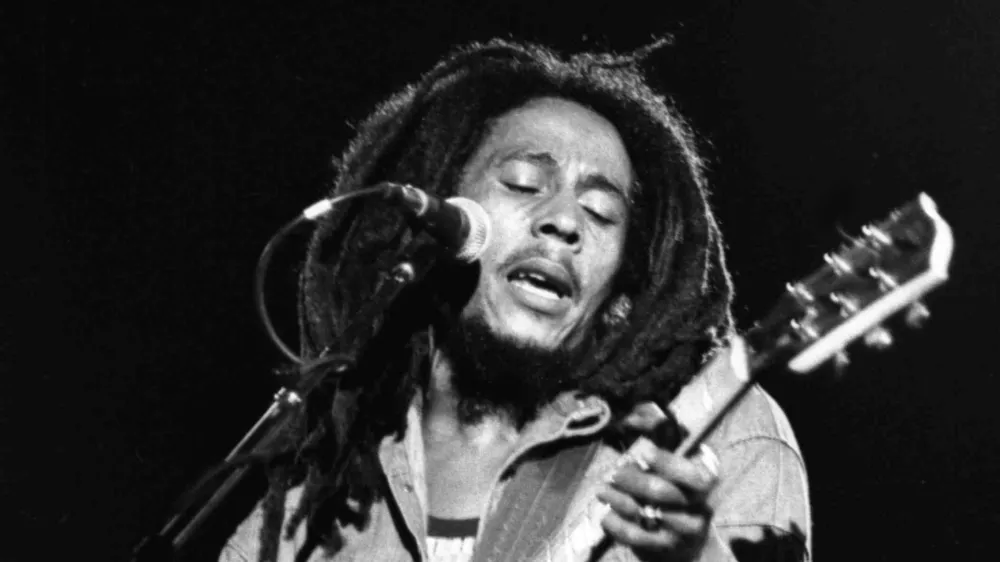 FILE - In this July 4, 1980 file photo, Jamaican Reggae singer Bob Marley performs in front of an audience of 40,000 during a concert in Paris. The Bob Marley documentary "Marley" will stream on Facebook simultaneously during its theatrical opening, a signal that social media may also play a role in shifting movie release windows. (AP File Photo)