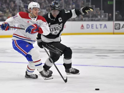 Feb 5, 2025; Los Angeles, California, USA;Montreal Canadiens center Jake Evans (71) and Los Angeles Kings center Anze Kopitar (11) chase down the puck in the second period at Crypto.com Arena. Mandatory Credit: Jayne Kamin-Oncea-Imagn Images