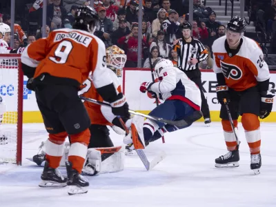 Washington Capitals' Alex Ovechkin, center right, gets the puck past Philadelphia Flyers' Ivan Fedotov, center left for a goal, during the first period of an NHL hockey game, Thursday, Feb. 6, 2025, in Philadelphia. (AP Photo/Chris Szagola)