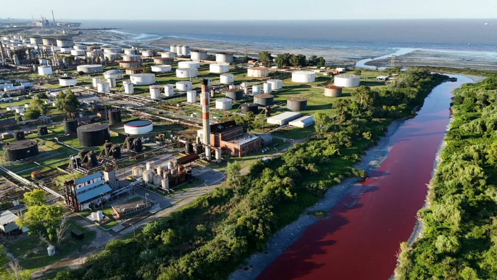 A drone view shows the Sarandi stream, which flows into the Rio de la Plata river, dyed red for unknown reasons, in Buenos Aires, Argentina February 6, 2025. REUTERS/Agustin Marcarian