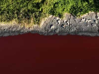 A drone view shows the Sarandi stream, which flows into the Rio de la Plata river, dyed red for unknown reasons, in Buenos Aires, Argentina February 6, 2025. REUTERS/Agustin Marcarian