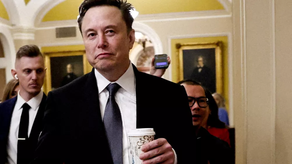 FILE PHOTO: Elon Musk walks on Capitol Hill on the day of a meeting with Senate Republican Leader-elect John Thune (R-SD), in Washington, U.S. December 5, 2024. REUTERS/Benoit Tessie/File Photo