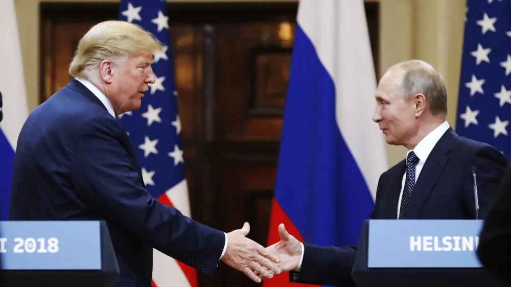 FILE - U.S. President Donald Trump shakes hands with Russian President Vladimir Putin at the end of a news conference at the Presidential Palace in Helsinki, Finland, on July 16, 2018. (AP Photo/Alexander Zemlianichenko, File)