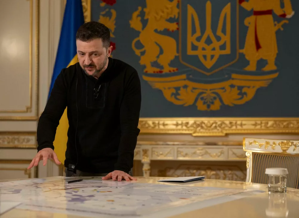 Ukraine's President Volodymyr Zelenskiy shows Reuters journalists a map of strategic resources and objects during an interview, amid Russia's attack on Ukraine, in Kyiv, Ukraine February 7, 2025. REUTERS/Valentyn Ogirenko