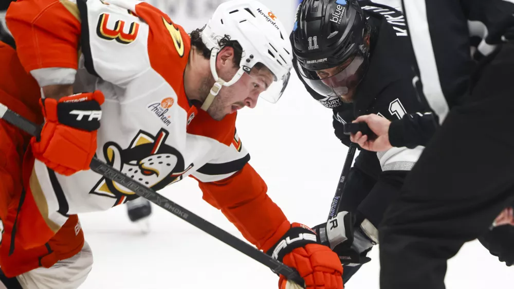 Feb 8, 2025; Los Angeles, California, USA; Los Angeles Kings center Anze Kopitar (11) prepares for a face off against Anaheim Ducks center Mason McTavish (23) during the second period of a hockey game at Crypto.com Arena. Mandatory Credit: Jessica Alcheh-Imagn Images