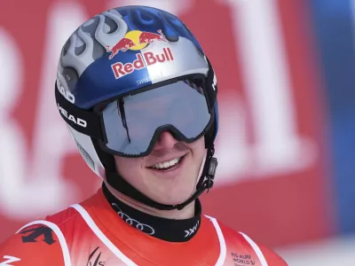 Switzerland's Franjo von Allmen celebrates at the finish area of a men's downhill race, at the Alpine Ski World Championships, in Saalbach-Hinterglemm, Austria, Sunday, Feb. 9, 2025. (AP Photo/Giovanni Auletta)