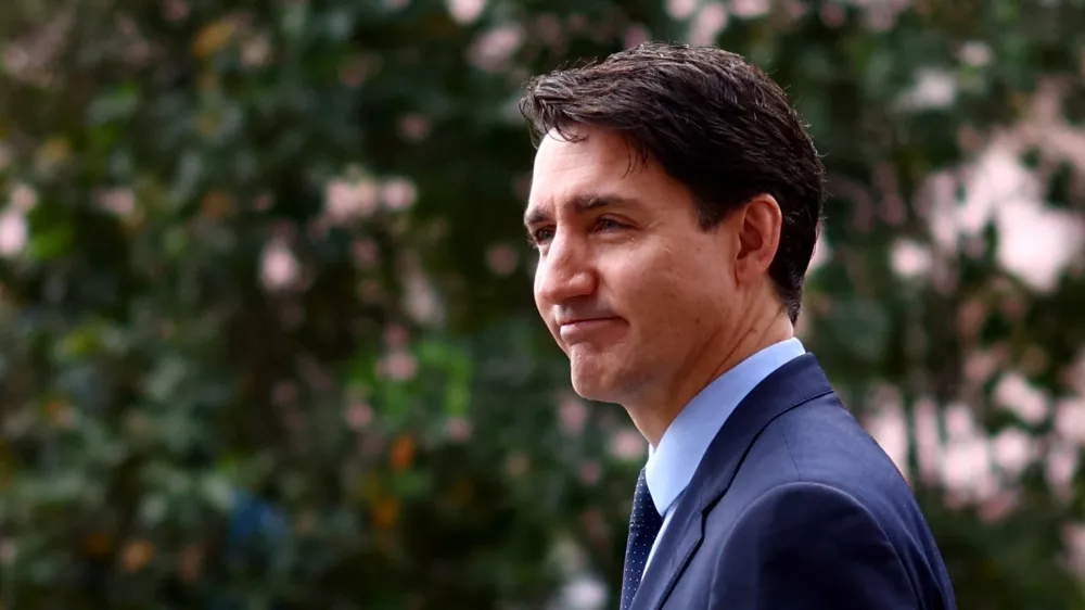 Canada's Prime Minister Justin Trudeau reacts at the Ismaili Centre Lisbon on the day of the funeral of Prince Karim Al-Hussaini Aga Khan IV, the spiritual leader of Ismaili Muslims, in Lisbon, Portugal, February 8, 2025. REUTERS/Pedro Nunes