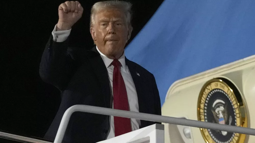 President Donald Trump gestures as he boards Air Force One at the Naval Air Station Joint Reserve Base in New Orleans, Sunday, Feb. 9, 2025. (AP Photo/Ben Curtis)