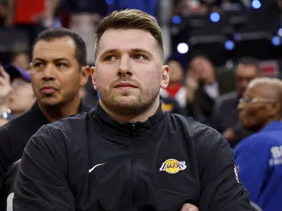 Los Angeles Lakers guard Luka Doncic sits on the bench before an NBA basketball game against the Los Angeles Clippers, Tuesday, Feb. 4, 2025, in Inglewood, Calif. (AP Photo/Kevork Djansezian)