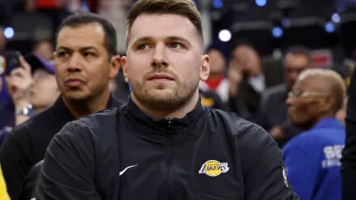 Los Angeles Lakers guard Luka Doncic sits on the bench before an NBA basketball game against the Los Angeles Clippers, Tuesday, Feb. 4, 2025, in Inglewood, Calif. (AP Photo/Kevork Djansezian)