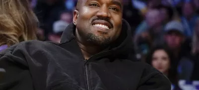 FILE - Kanye West watches the first half of an NBA basketball game between the Washington Wizards and the Los Angeles Lakers in Los Angeles, on March 11, 2022. Former President Donald Trump had dinner Tuesday, Nov. 22, at his Mar-a-Lago club with the rapper formerly known as Kanye West, who is now known as Ye, as well as Nick Fuentes, a far-right activist who has used his online platform to spew antisemitic and white supremacist rhetoric. (AP Photo/Ashley Landis, File)