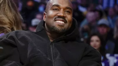 FILE - Kanye West watches the first half of an NBA basketball game between the Washington Wizards and the Los Angeles Lakers in Los Angeles, on March 11, 2022. Former President Donald Trump had dinner Tuesday, Nov. 22, at his Mar-a-Lago club with the rapper formerly known as Kanye West, who is now known as Ye, as well as Nick Fuentes, a far-right activist who has used his online platform to spew antisemitic and white supremacist rhetoric. (AP Photo/Ashley Landis, File)