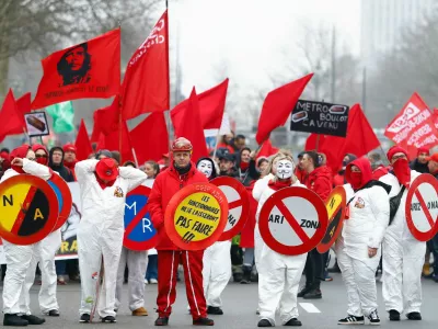 Protesting workers and trade union members hold flags and signs during a national strike demanding stronger public services in Brussels, Belgium February 13, 2025. REUTERS/Stephanie Lecocq